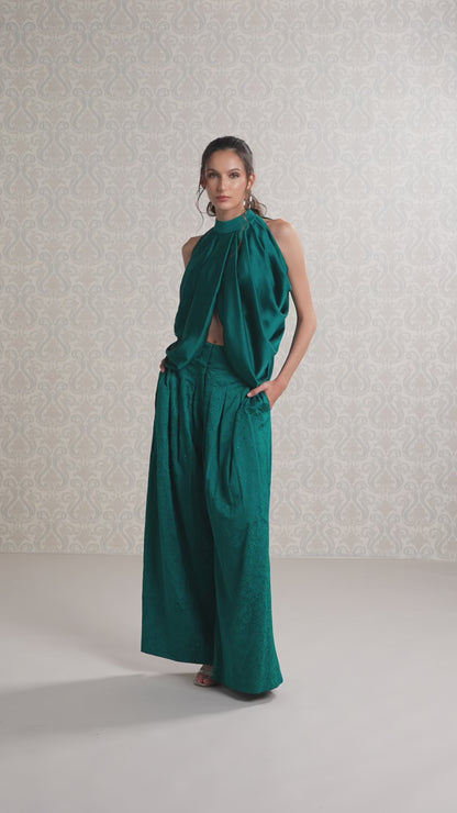 Model walking in emerald satin top and trouser co-ord set showing flow and style