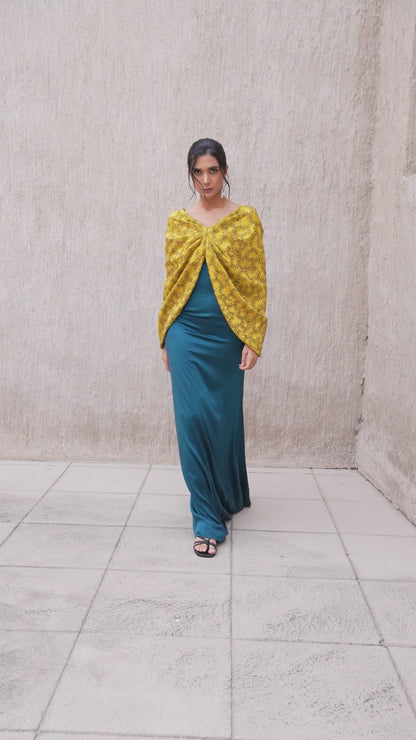 Model walking in harvest gold and moonlight blue kaftan ensemble