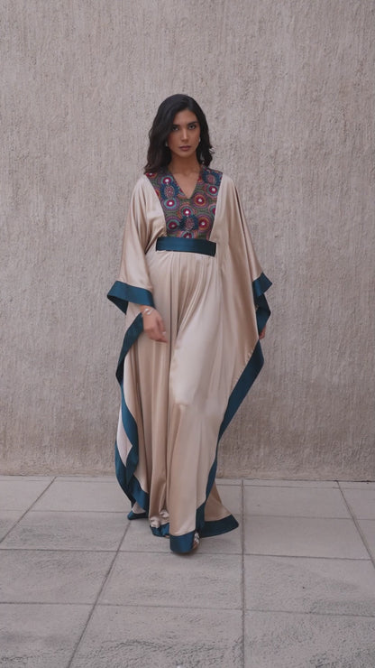 Model walking in vanilla and moonlight blue embroidered kaftan