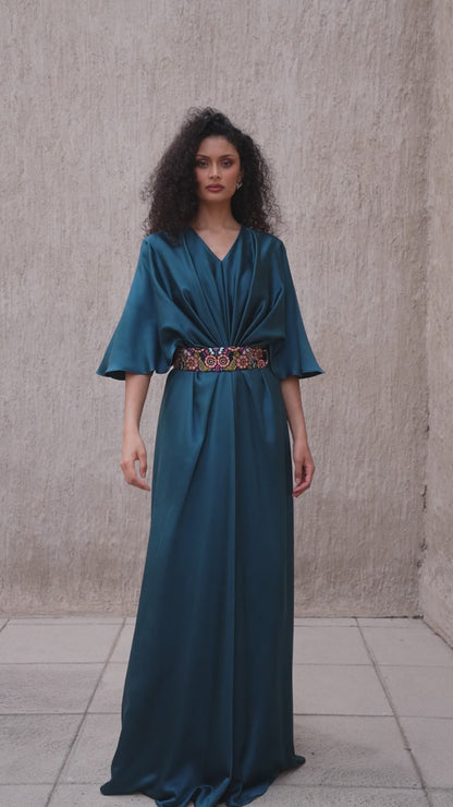 Model walking in moonlight blue evening gown with cinched waist