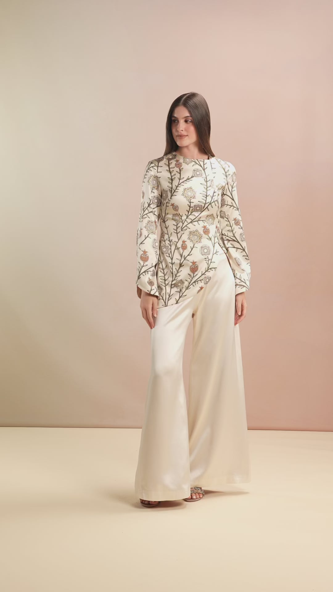 Model walking in Champagne embroidered Top with flowy trousers