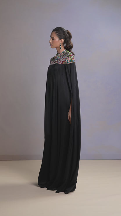 Model walking in elegant Midnight Black silk kaftan with embroidered yoke