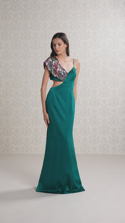 Model showcasing movement of emerald silk satin long dress with printed draped shoulder