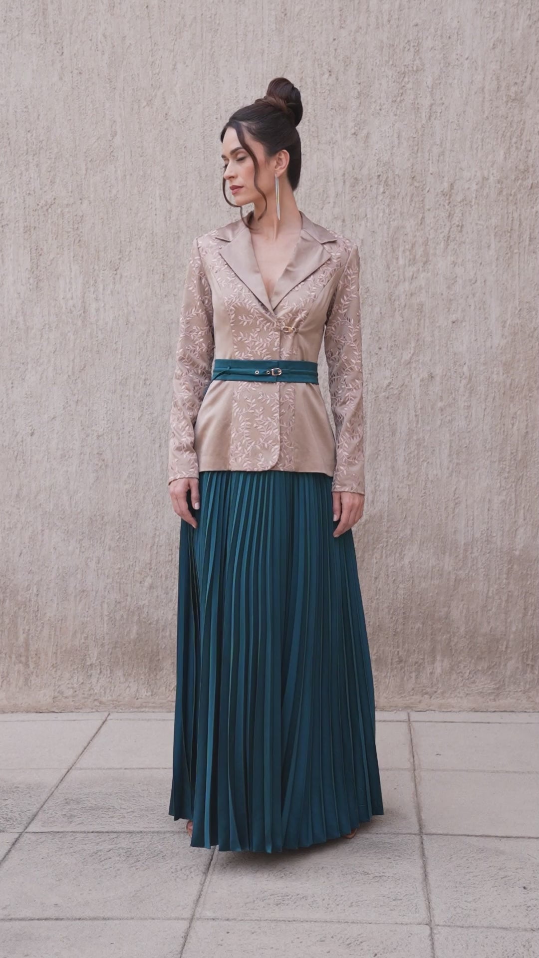 Model walking in brown oak blazer and moonlight blue pleated skirt