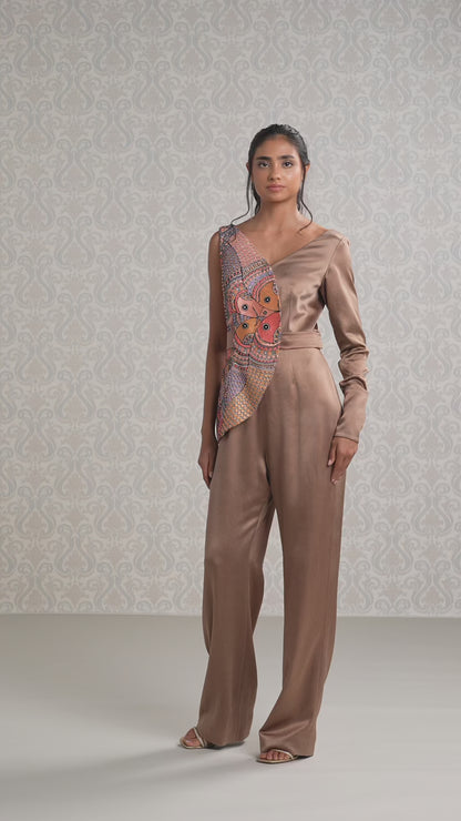 Women walking in vanilla and brown silk satin jumpsuit with artistic one-shoulder design