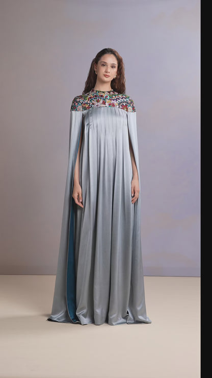 Model showcasing glacier blue embroidered silk kaftan in motion
